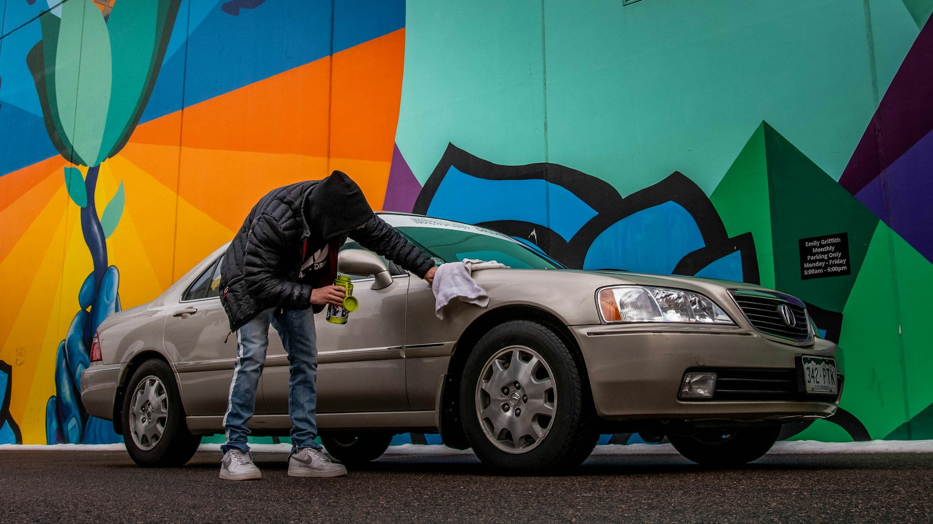 A guy cleaning his used car